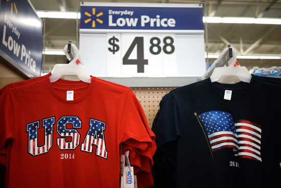 T-shirts made in the USA are on sale for $4.88 at the Walmart Supercenter in Bentonville, Arkansas June 5, 2014.  The Walmart Stores Inc. annual shareholder meeting takes place June 6, 2014.  REUTERS/Rick Wilking (UNITED STATES - Tags: BUSINESS) - RTR3SESG